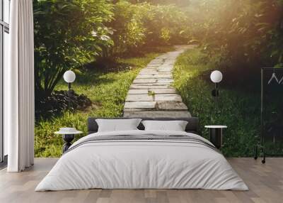 Stone walkway in the green garden with sun light Wall mural