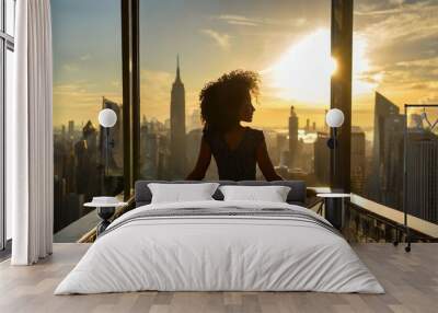 Successful woman standing on luxury balcony, back view of rich female silhouette at sunset in New York city Wall mural