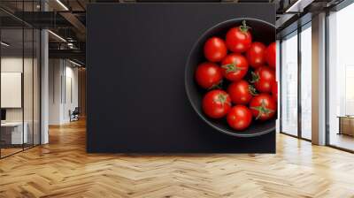 Tomato in a bowl on a black background, top view, copy space Wall mural