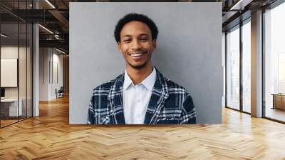 Young man with beautiful smile on grey background. Teeth whitening Wall mural