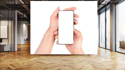 A man's hands hold a smartphone with a white screen isolated on a white background. Close-up. Wall mural