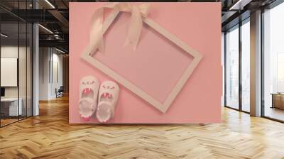 Childrens shoes for girls, stands on a pink background. on frame with ribbon. Closeup view from the top. the concept of children's clothing. Copyspace included. Wall mural