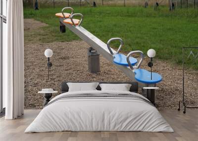 Children's swing on the outdoor playground. We also see colored seats. Wall mural