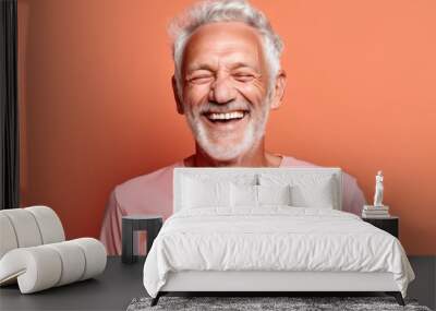 Close-up portrait photography of a joyful old man wearing a casual t-shirt against a coral pink background. With generative AI technology Wall mural