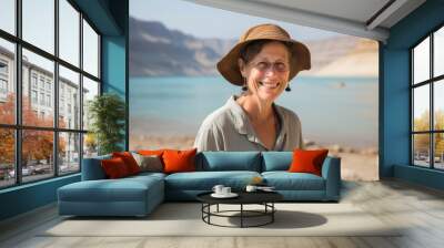 Environmental portrait photography of a glad mature woman wearing a breathable golf polo at the dead sea in israel/jordan. With generative AI technology Wall mural