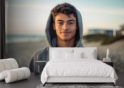 Environmental portrait photography of a satisfied boy in his 30s wearing a stylish hoodie against a beach background. With generative AI technology Wall mural