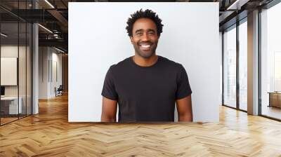 Portrait of a cheerful afro-american man in his 30s dressed in a casual t-shirt in white background Wall mural