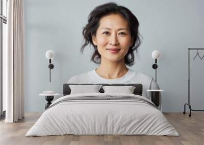 Portrait of a content asian woman in her 40s sporting a breathable mesh jersey against a white background. AI Generation Wall mural