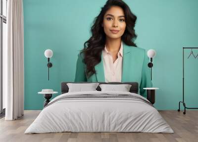 Portrait of a content indian woman in her 20s wearing a professional suit jacket against a pastel teal background. AI Generation Wall mural