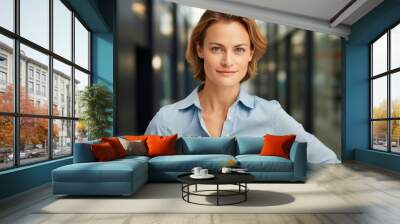 Portrait of a merry woman in her 30s donning a classy polo shirt isolated on sophisticated corporate office background Wall mural