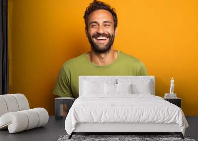 Portrait of a smiling man in his 30s donning a trendy cropped top over solid color backdrop Wall mural