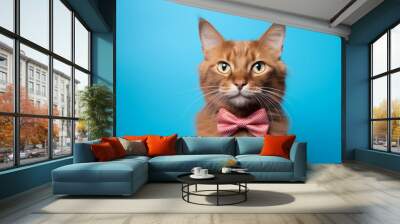 somali cat wearing a nifty bow tie against a cerulean blue background Wall mural