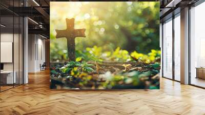 Christian cross made of rock standing on a green grass nature Wall mural