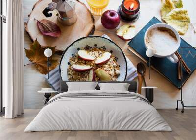 Autumn style breakfast with apple muesli bowl, coffee, book and candle Wall mural