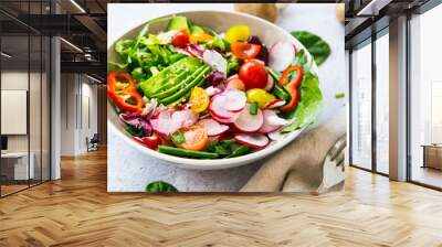 Fresh vegetable salad bowl closeup, healthy organic vegetables salad with radish, spinach, tomatoes, onion, avocado Wall mural