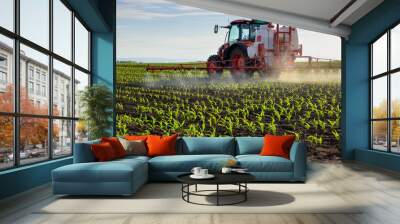 Tractor spraying young corn with pesticides Wall mural