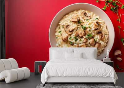 A delicious mushroom risotto garnished with microgreens, isolated against a vibrant red background with a soft gradient Wall mural