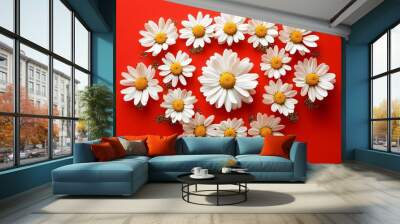 Chamomile arranged in a symmetrical, modern abstract design, isolated on a bold red background with metallic elements Wall mural