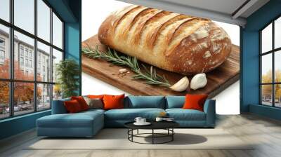 Crusty rustic bread loaf, isolated on a wooden cutting board with decorative sprigs of rosemary and garlic cloves Wall mural