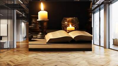 Prayer book on table with candles Wall mural