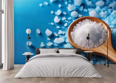 coarse salt crystals on a blue table wooden spoon with sea salt background for advertising salty banner Wall mural