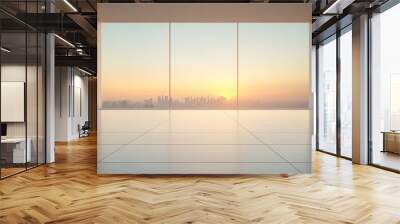 A large, empty room with a window overlooking a city skyline Wall mural