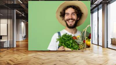 Beauty portrait of man surrounded by various healthy food lying. Healthy eating and sports lifestyle concept Wall mural