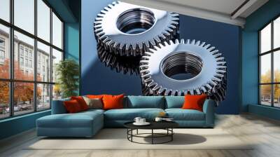 Two metal gears resting on a blue metallic background, ideal for industrial backgrounds Wall mural