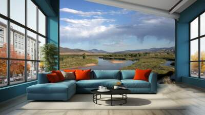 The Green River and riparian landscape with sand bars and dry rain overhead at Browns Park National Wildlife Refuge in Colorado Wall mural