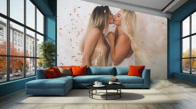 2 girls sharing a kiss of friendship at a party, happy and joyful times celebration Wall mural