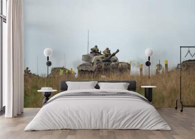 2 soldiers atop a tank with guns Wall mural