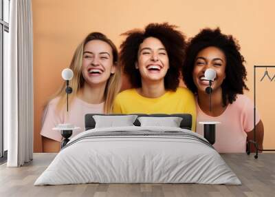 3 females having fun and laughing on plain background Wall mural