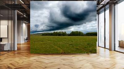 a dark black shelf cloud in a foreboding dark grey thunder storm cloud sky bringing heavy rain over open countryside Wall mural