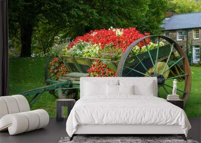 a vintage wooden cart converted to house a summer bloom of beautiful flowers in Beddgelert Caernarfon Wales UK Wall mural