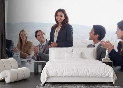 Coworkers clapping for businesswoman in conference room Wall mural