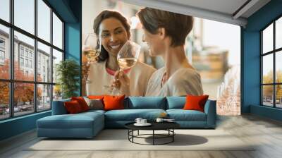 Smiling women wine tasting white wine in winery tasting room Wall mural