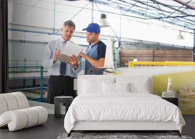 Supervisor and worker with clipboard in food processing plant Wall mural