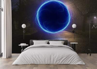 Dark alley with blue portal at misty cold night Wall mural