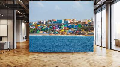 Colorful houses line the hill side overlooking the beach in San Juan, Puerto Rico. Wall mural