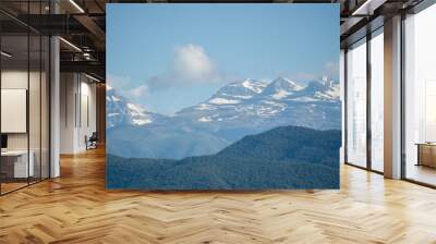 distant Spanish pyrenees mountains with low white cloud under a blue summer sky Wall mural