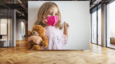 girl with teddy bear and face mask during illness Wall mural