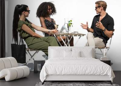 Group of elegant young people sitting in an outdoor café isolated on white background Wall mural