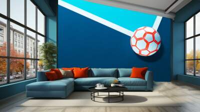 Close-up of a white futsal soccer ball laying on the line in the corner of a blue indoor soccer field Wall mural