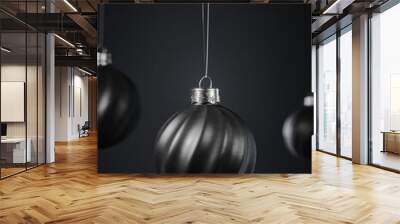 Three twisted striped black Christmas balls against dark gray background. Wall mural