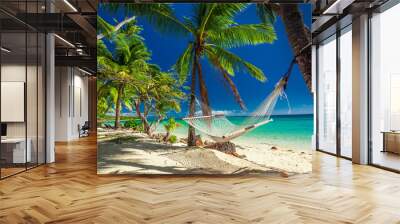 Empty hammock in the shade of palm trees on tropical Fiji Wall mural