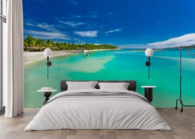 Palm trees on a white sandy beach at Plantation Island, Fiji, South Pacific Wall mural