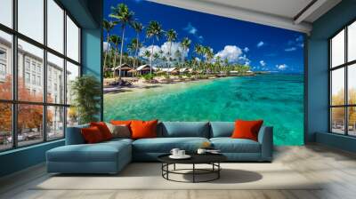 Tropical beach with with coconut palm trees and villas on Samoa Wall mural