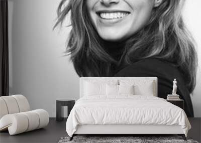 Black and white portrait of a young happy woman with a big smile on her face Wall mural