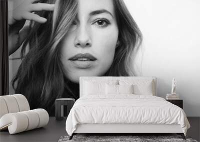 Black and white portrait of a young serious woman looking directly in camera Wall mural