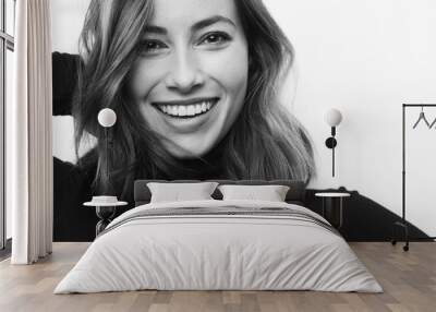 Black and white portrait of young happy woman with a big smile on her face looking in camera Wall mural